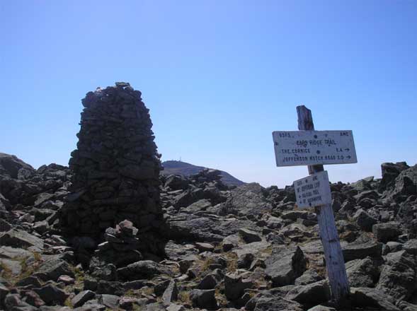 Cairn on Mount Jefferson's summit with Mount Washington visible in the background (photo by Kathy Veilleux)
